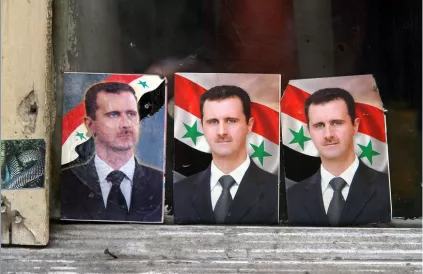 Portretten van Bashar al-Assad verdwijnen uit het straatbeeld. Foto: James Gordon/CC BY-SA 2:0)