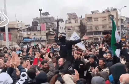 Aanhangers van de nieuwe Syrische regering zwaaien met al-Qaeda- en regimevlaggen en roepen op tot jihad tegen Alawieten, Damascus 7 maart. Foto: printscreen via X 